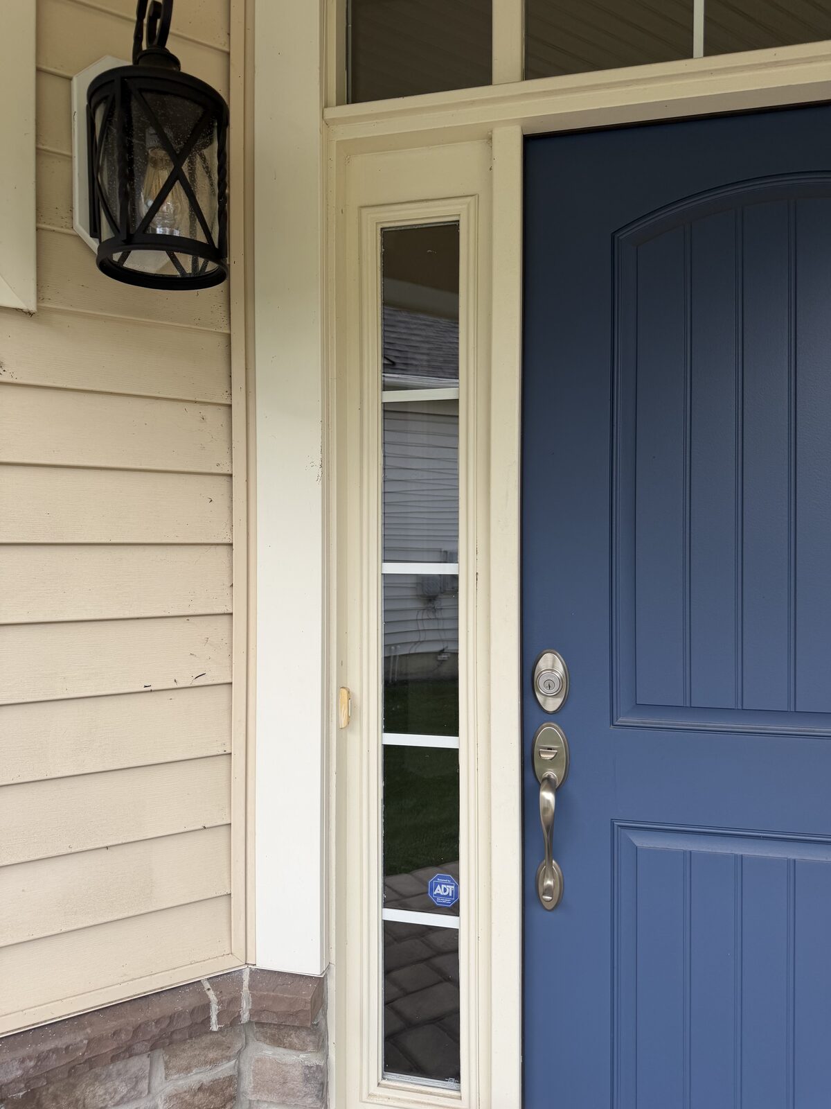 Spotless front entry sidelight glass and clean trim after service
